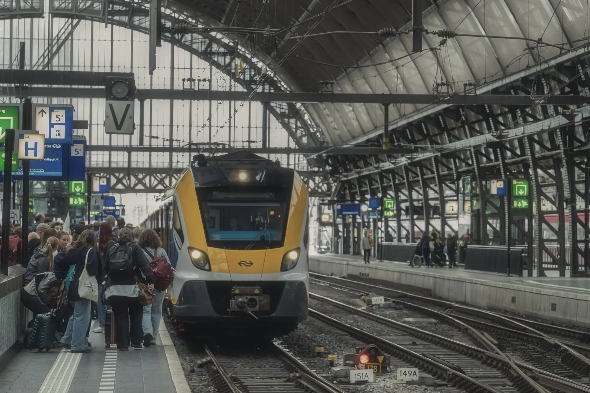 A train pulling into a busy platform at Amsterdam Centraal station